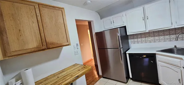 a kitchen with metallic refrigerator freezer and a dishwasher