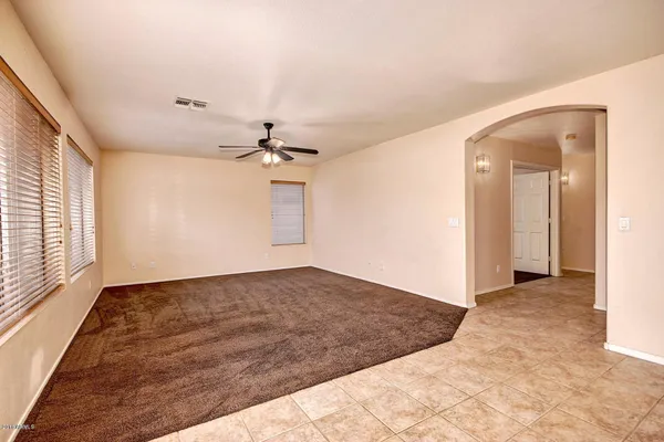 a view of a livingroom with a ceiling fan and window