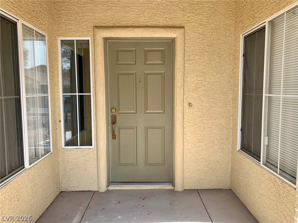 3821 Bombastic Court Las Vegas, NV 89147 - Photo 3 of 36 This inviting entry features a classic panel door, offering a warm welcome.