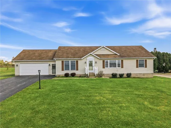 a front view of a house with a yard