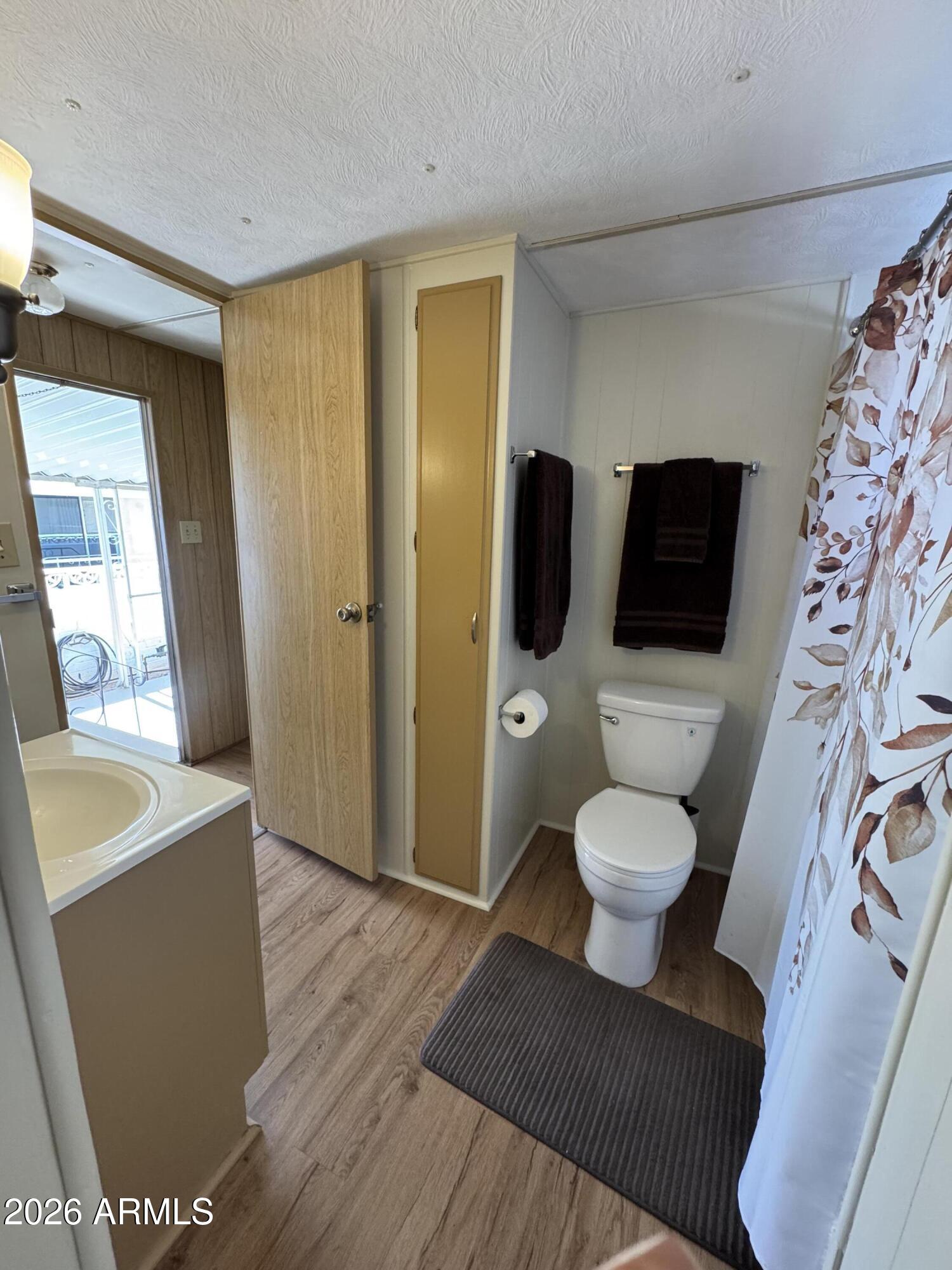 269 North Winchester Road, Unit 36 Apache Junction, AZ 85119 - Photo 14 of 19 a bathroom with a toilet sink and mirror