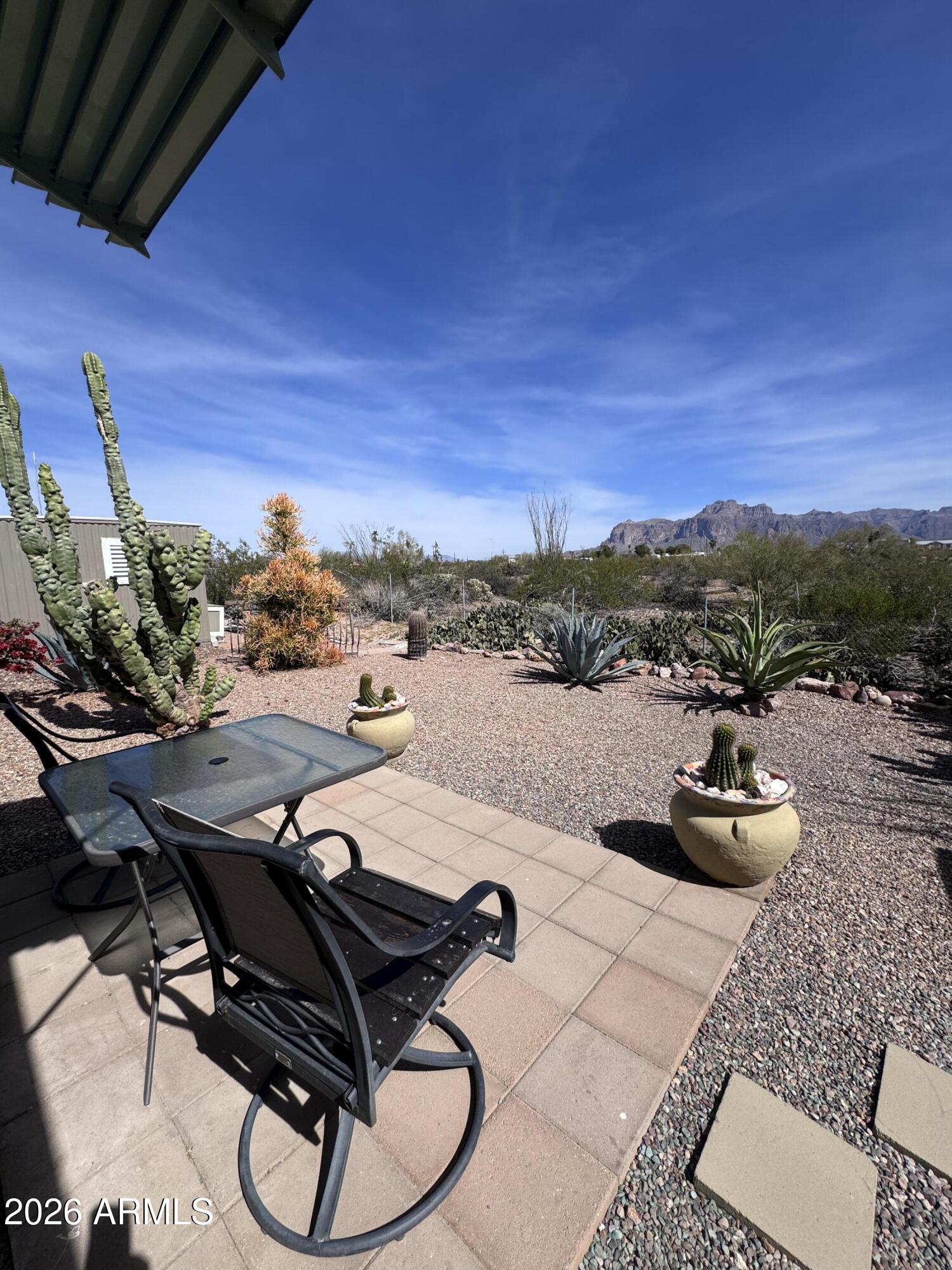 269 North Winchester Road, Unit 36 Apache Junction, AZ 85119 - Photo 16 of 19 a view of a balcony with chairs and wooden floor