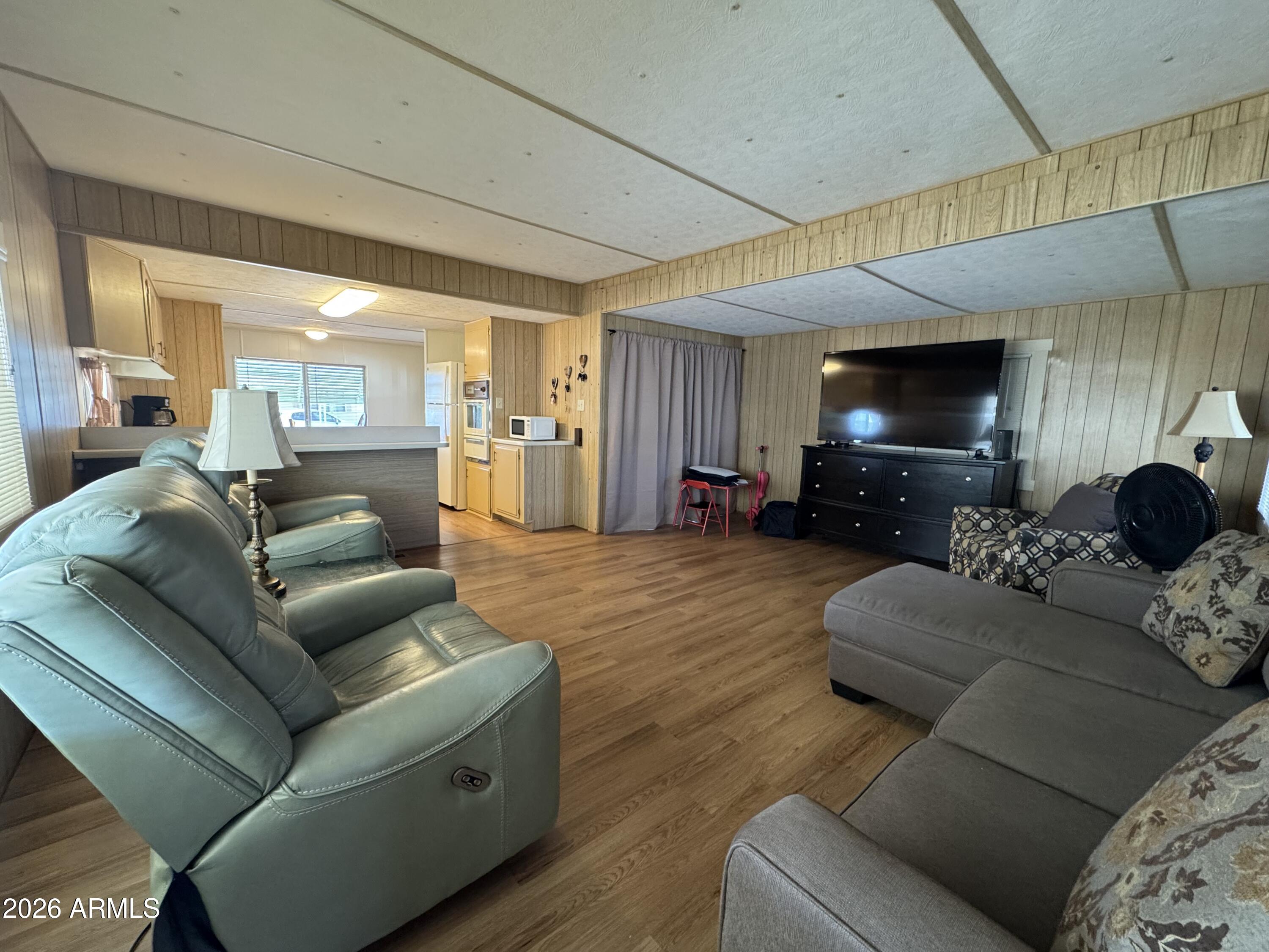 269 North Winchester Road, Unit 36 Apache Junction, AZ 85119 - Photo 2 of 19 a living room with furniture and a flat screen tv