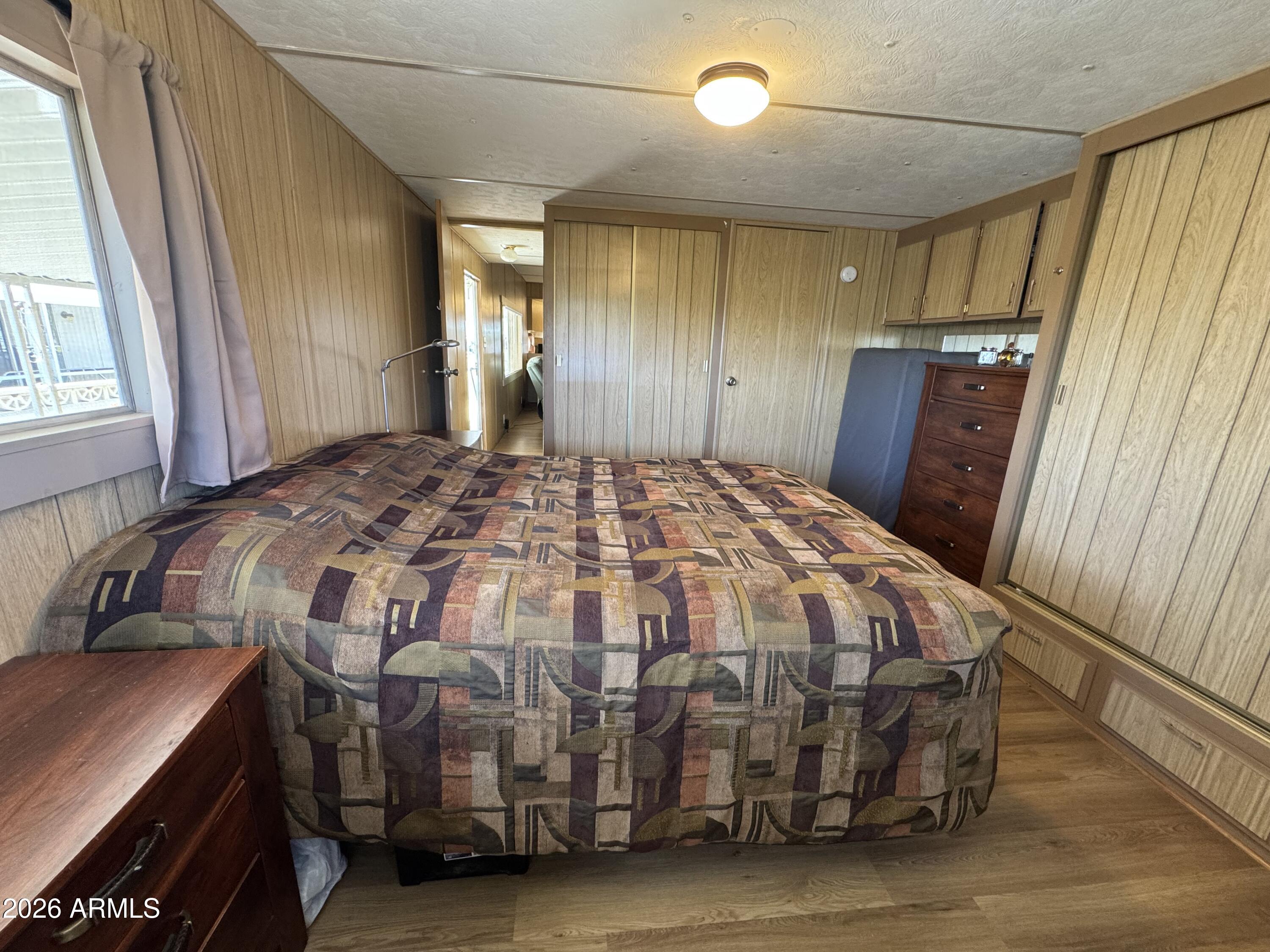 269 North Winchester Road, Unit 36 Apache Junction, AZ 85119 - Photo 10 of 19 a bedroom with a bed and wooden floor