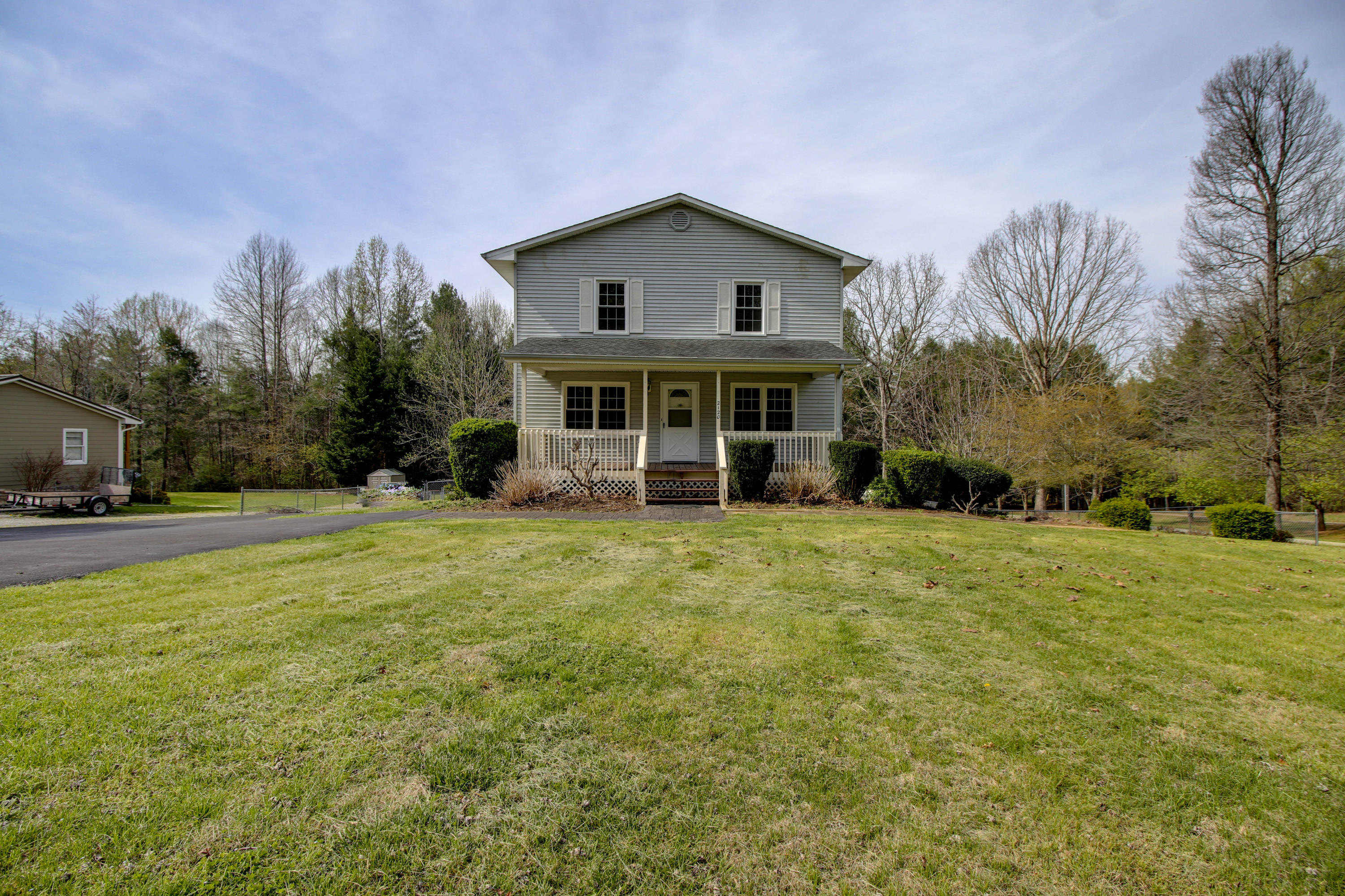 a view of house with outdoor space and garden