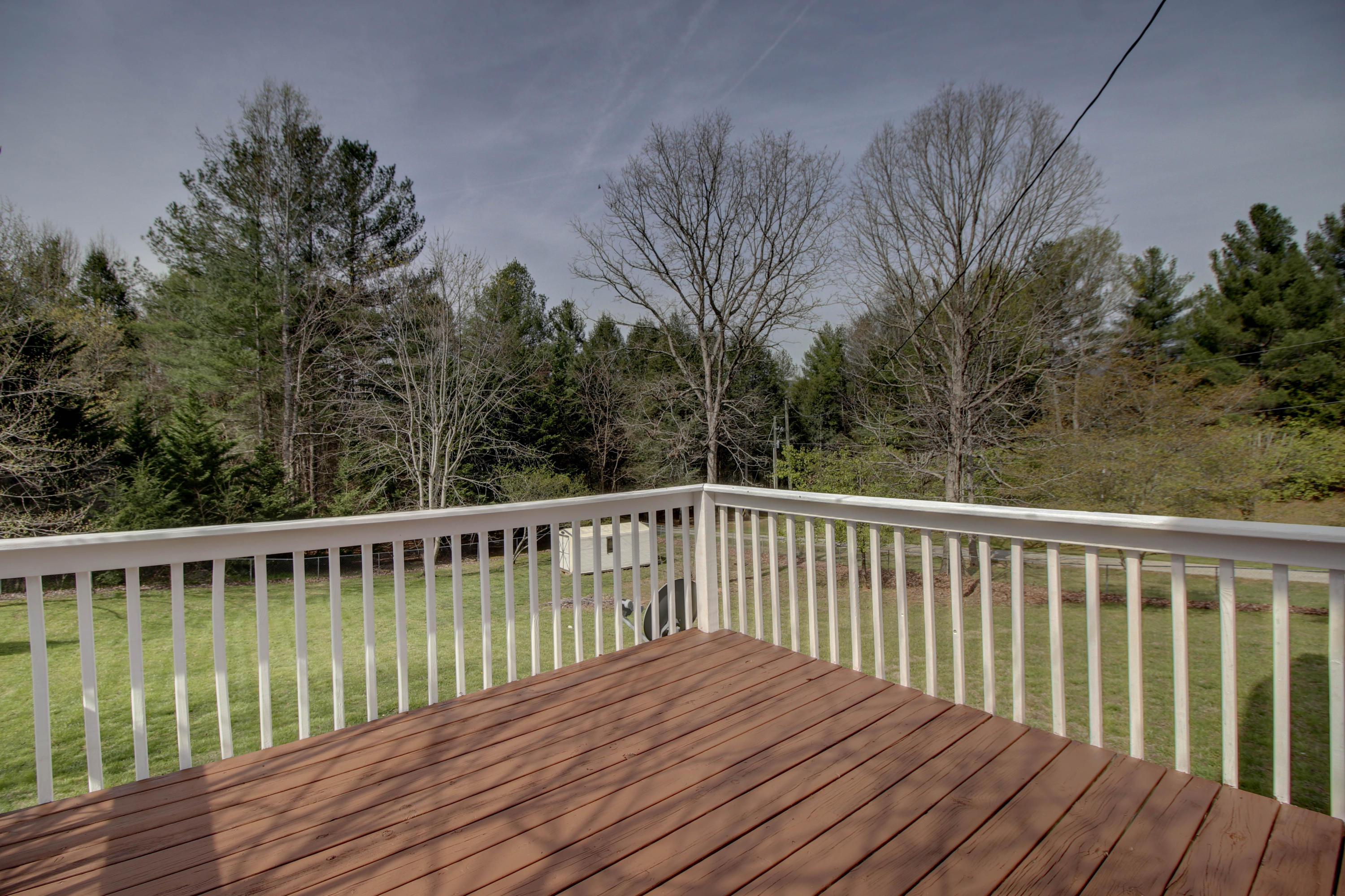 2120 Dugspur Road Callaway, VA 24067 - Photo 10 of 40 a wooden deck with trees in front of it