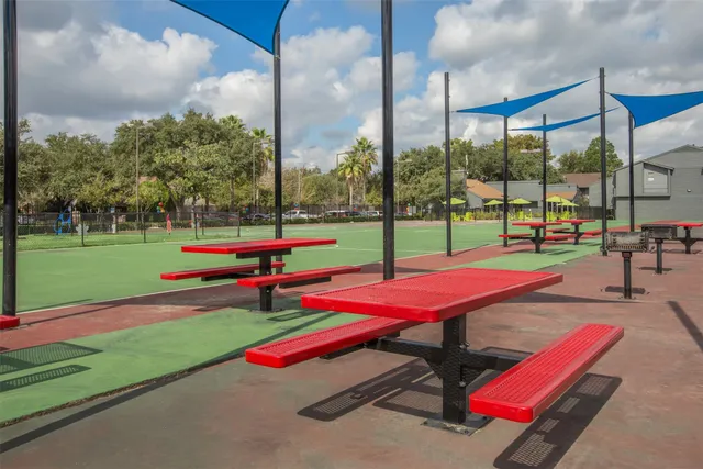 a view of a playground with basketball court