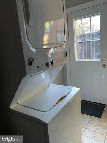 a room with exposed pipes and a window