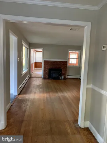 a view of empty room with a fireplace and window