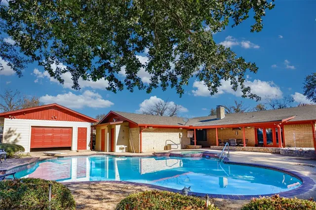 a front view of house with yard and car parked