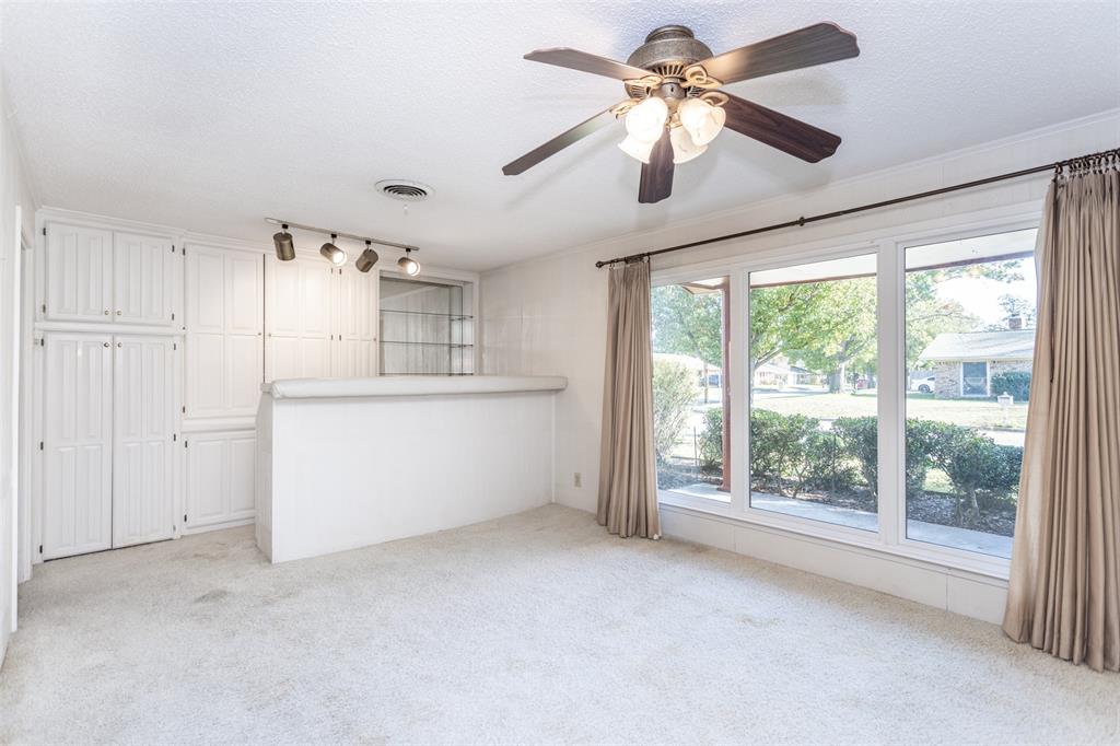 417 Willow Way Gainesville, TX 76240 - Photo 17 of 40 a view of a big room with windows and chandelier fan
