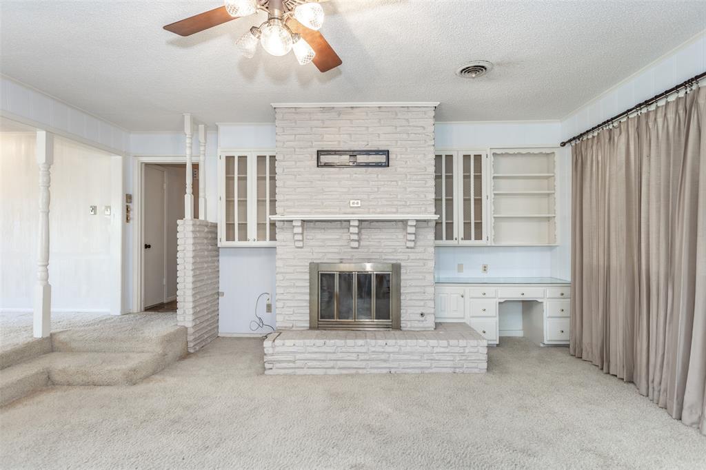 417 Willow Way Gainesville, TX 76240 - Photo 23 of 40 a living room with furniture and a fireplace