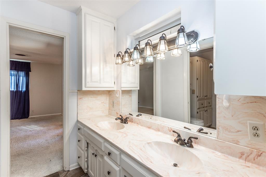 417 Willow Way Gainesville, TX 76240 - Photo 38 of 40 a bathroom with a double vanity sink and a mirror