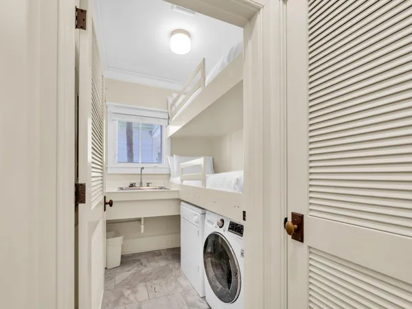 a view of a hallway with washer and dryer
