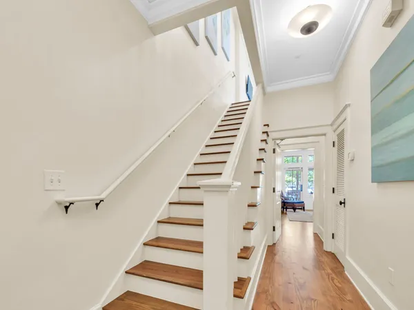 a view of entryway with wooden floor and stairs