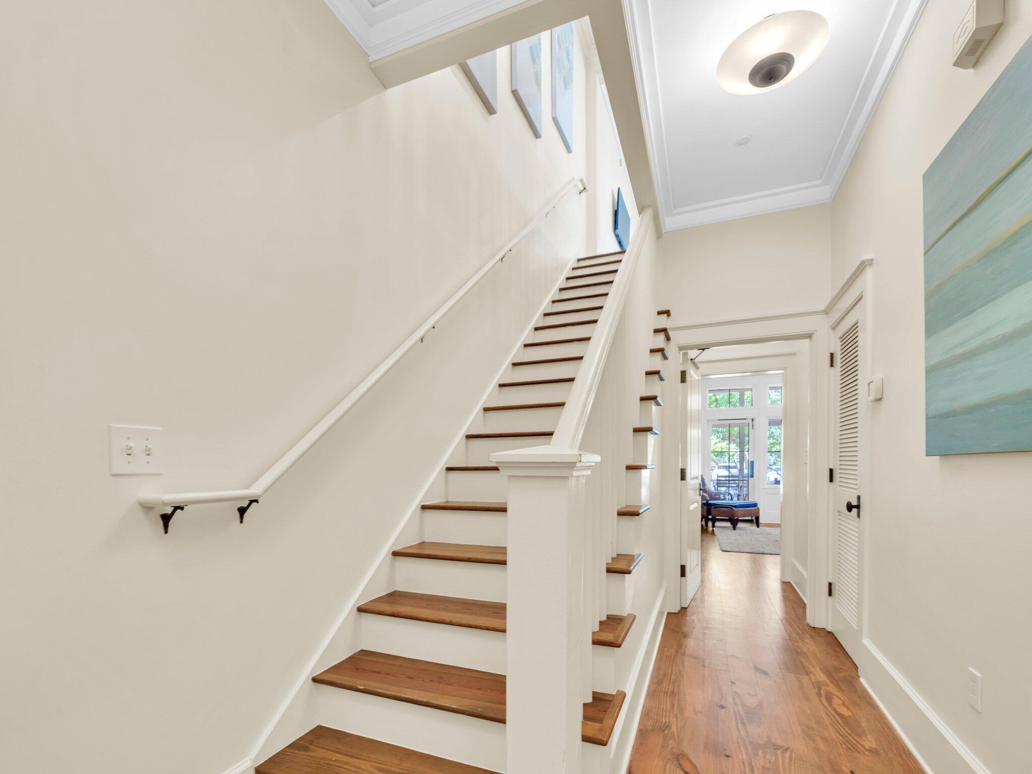 1660 East County Highway 30A, Unit 102 Santa Rosa Beach, FL 32459 - Photo 16 of 48 a view of entryway with wooden floor and stairs