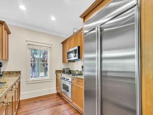 a kitchen with a refrigerator and a stove