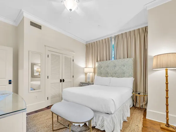 a bedroom with a bed and a lamp