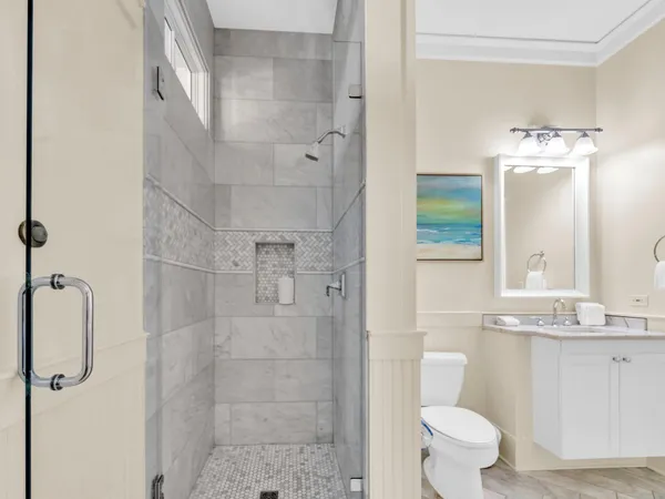 a bathroom with a sink toilet and shower