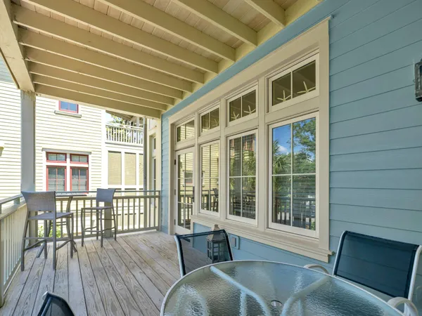 a balcony with table and chairs