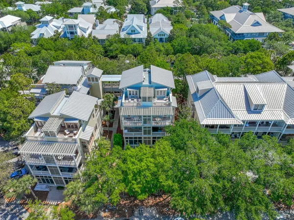 an aerial view of multiple houses with a yard
