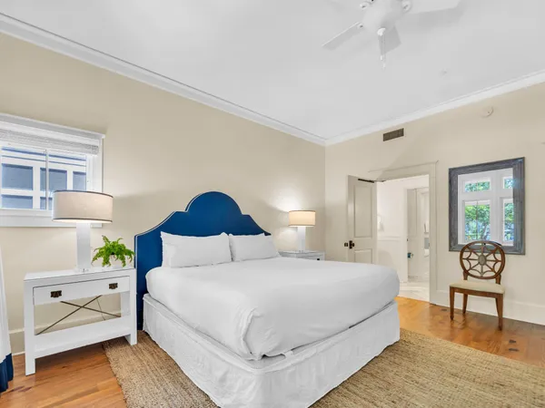 a bedroom with a bed and wooden floor