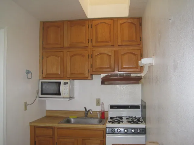 a kitchen with granite countertop cabinets and black stainless steel appliances