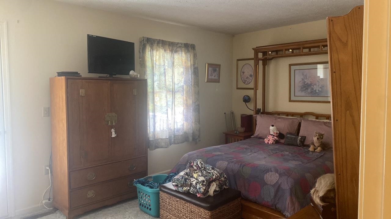 700 Rife Road, Unit 7F Waynesboro, VA 22980 - Photo 17 of 20 a bedroom with a bed and wooden floor