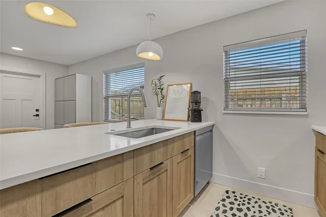 a kitchen with sink refrigerator and microwave