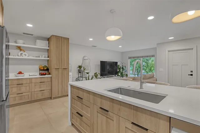 a kitchen with stainless steel appliances a refrigerator and cabinets