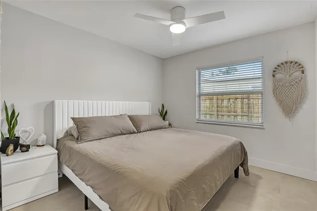 a bedroom with a bed and a painting on the wall