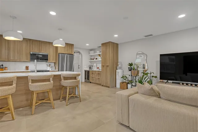 a living room with furniture and a large window