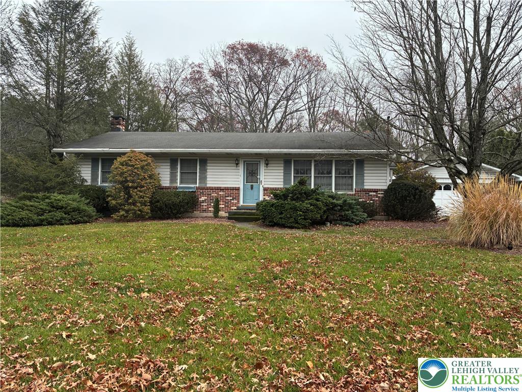 a front view of house with yard and green space