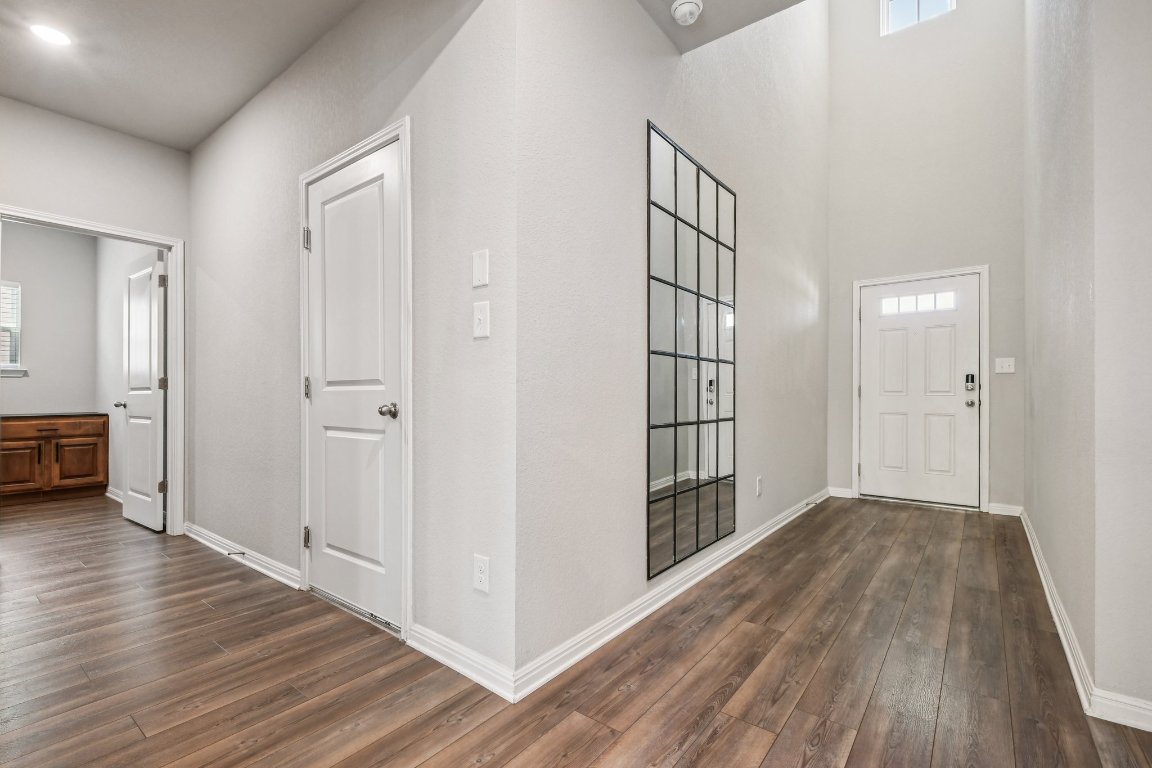 1007 Guadalupe Bass Road Hutto, TX 78634 - Photo 13 of 39 Entryway with plenty of natural light and dark wood-type flooring