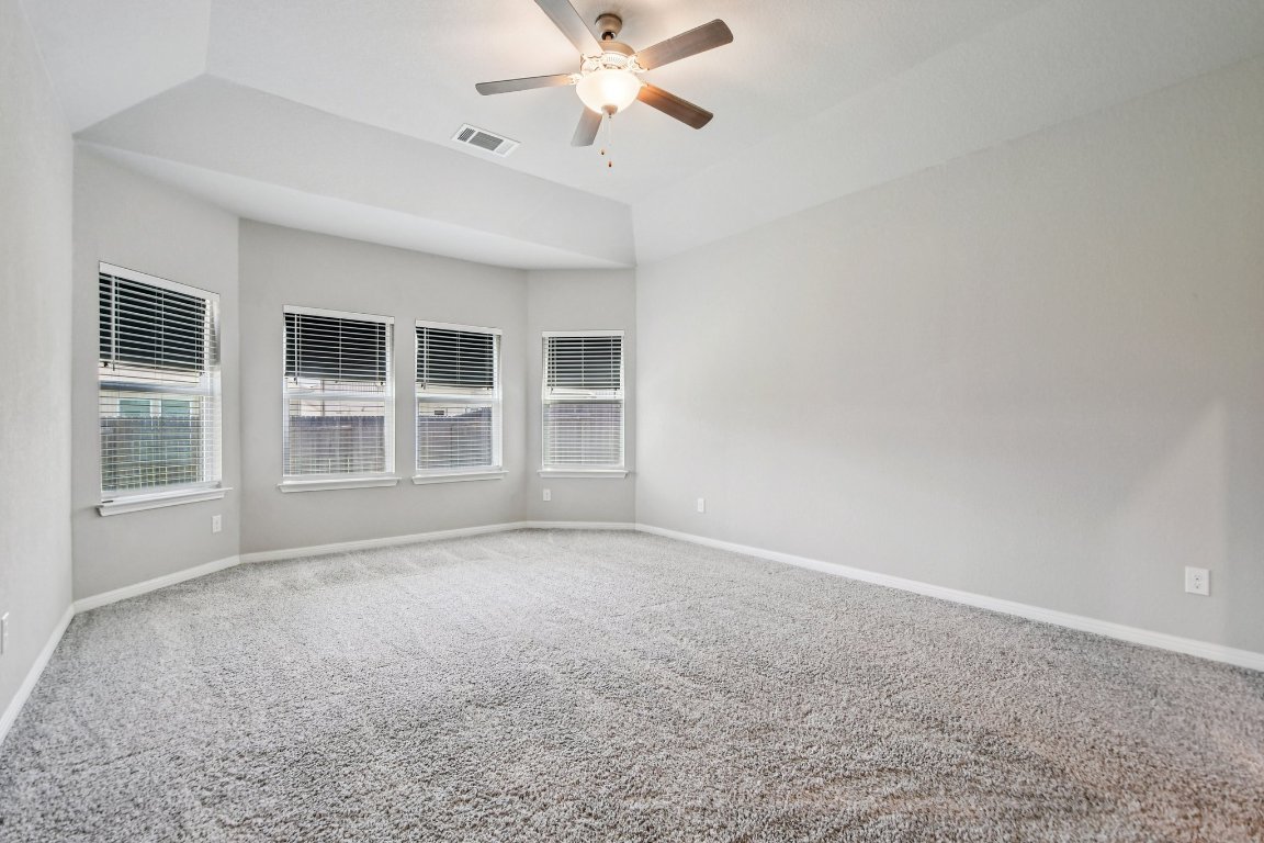 1007 Guadalupe Bass Road Hutto, TX 78634 - Photo 16 of 39 Empty room with carpet flooring and ceiling fan