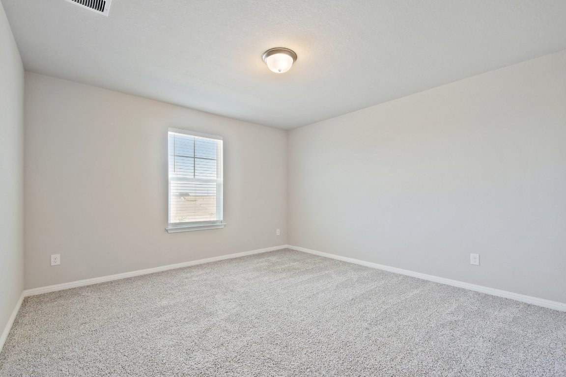 1007 Guadalupe Bass Road Hutto, TX 78634 - Photo 22 of 39 Spare room with baseboards and carpet floors
