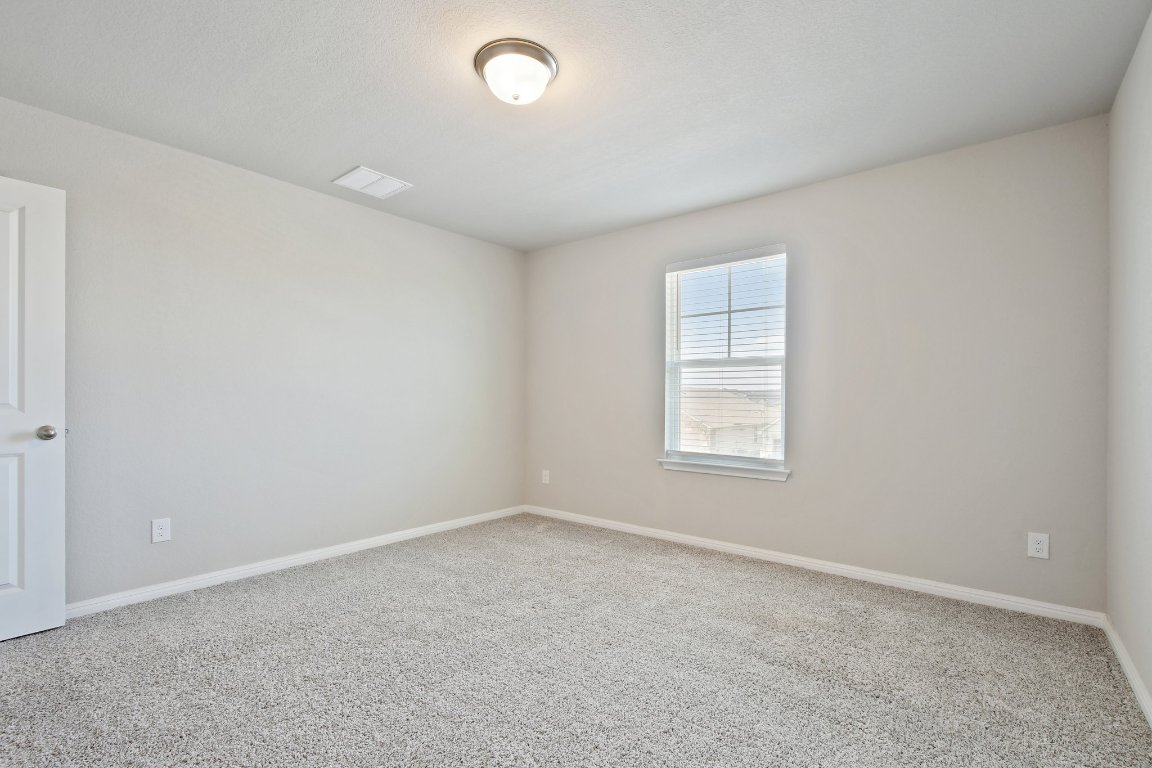 1007 Guadalupe Bass Road Hutto, TX 78634 - Photo 23 of 39 Unfurnished room with baseboards and carpet flooring