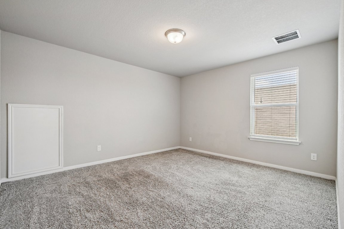1007 Guadalupe Bass Road Hutto, TX 78634 - Photo 28 of 39 Carpeted spare room with baseboards