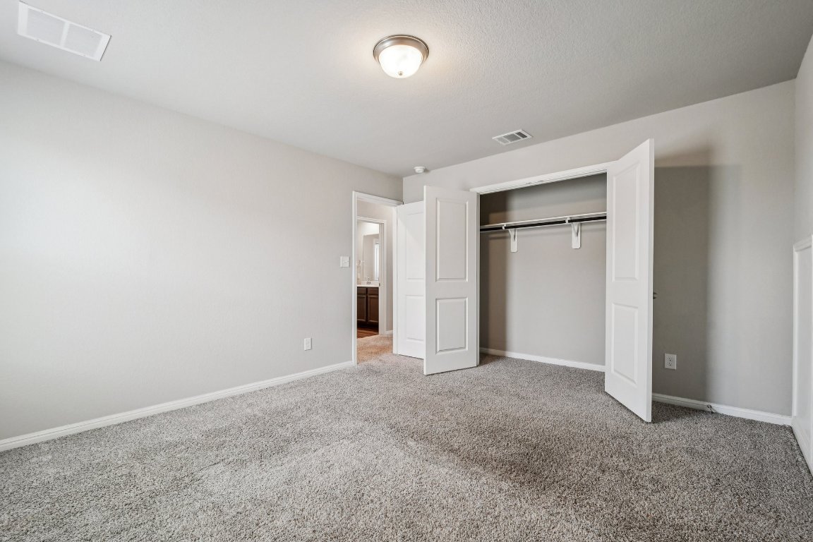 1007 Guadalupe Bass Road Hutto, TX 78634 - Photo 29 of 39 Unfurnished bedroom with carpet floors and a closet