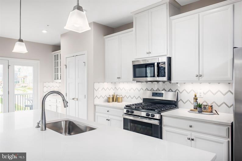 121 Brown Branch Road Laurel, MD 20708 - Photo 3 of 16 a kitchen with granite countertop a stove and a sink