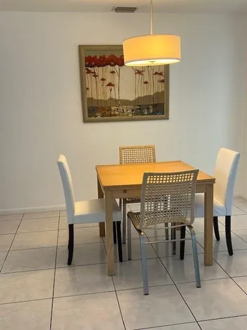 a dining room with a table and chairs