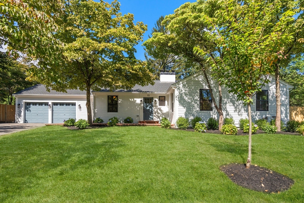 a view of a house with a big yard and large trees