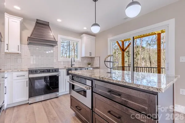 a kitchen with granite countertop a stove and a sink
