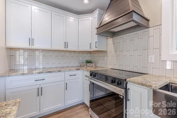 a kitchen with a sink stove and cabinets