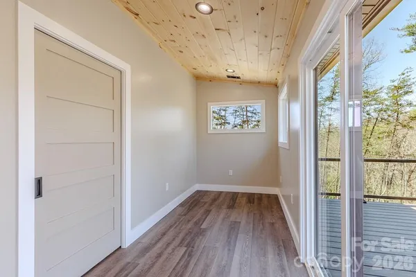 a view of a hallway with a wooden floor