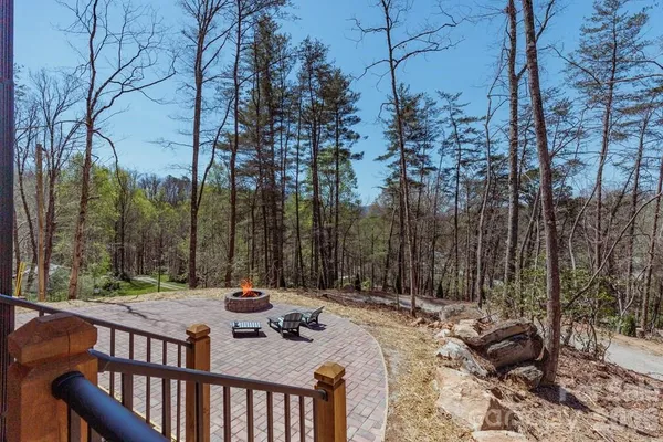 a view of a patio with a table chairs and a fire pit