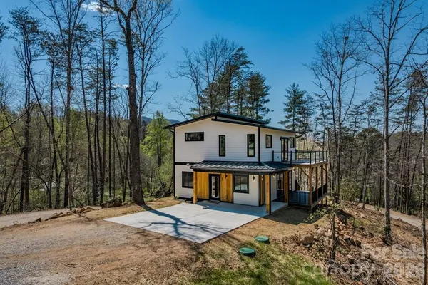 a view of a house with a yard next to a road
