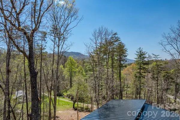 a view of a wooden deck and trees