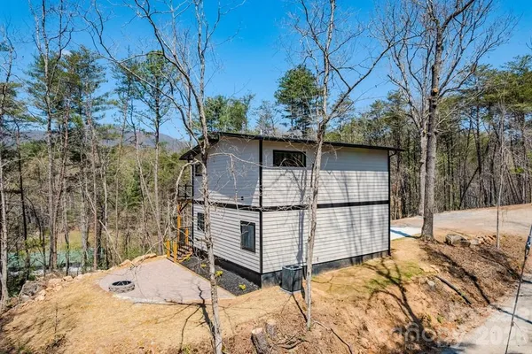 a white house that has tree in front of it