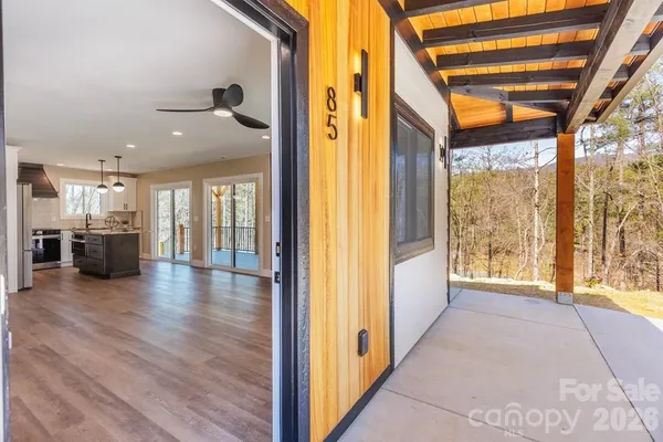 a view of an entryway with wooden floor and windows